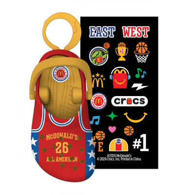 Red crocs in a red jersey with blue sides, white stars and yellow writing and a colorful sticker pack