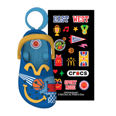 Blue crocs with a basketball flying towards a red basketball hoop, yellow arches and smile and a colorful sticker pack