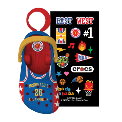 Blue crocs in a blue jersey with red sides, white stars and yellow writing and a colorful sticker pack