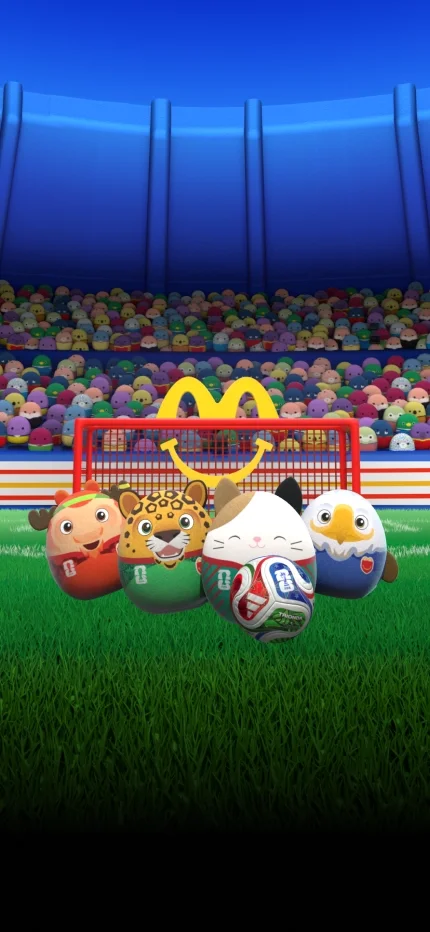 Cam celebrates with mascots Maple, Zayu and Clutch in front of the Happy Meal goal.